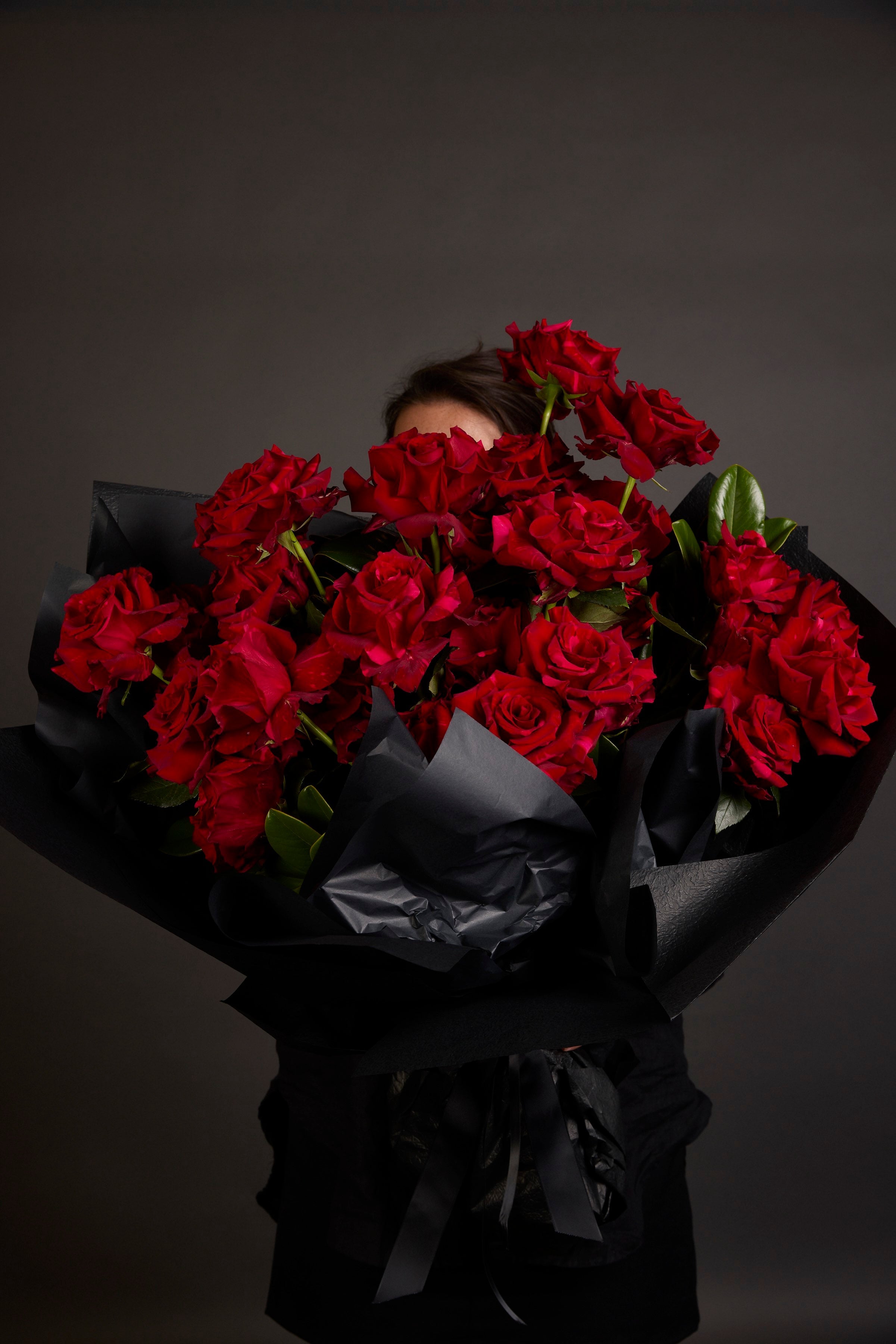 Luxury rose bouquet by Victoria Whitelaw featuring long-stem roses in signature black wrap, delivered across Melbourne