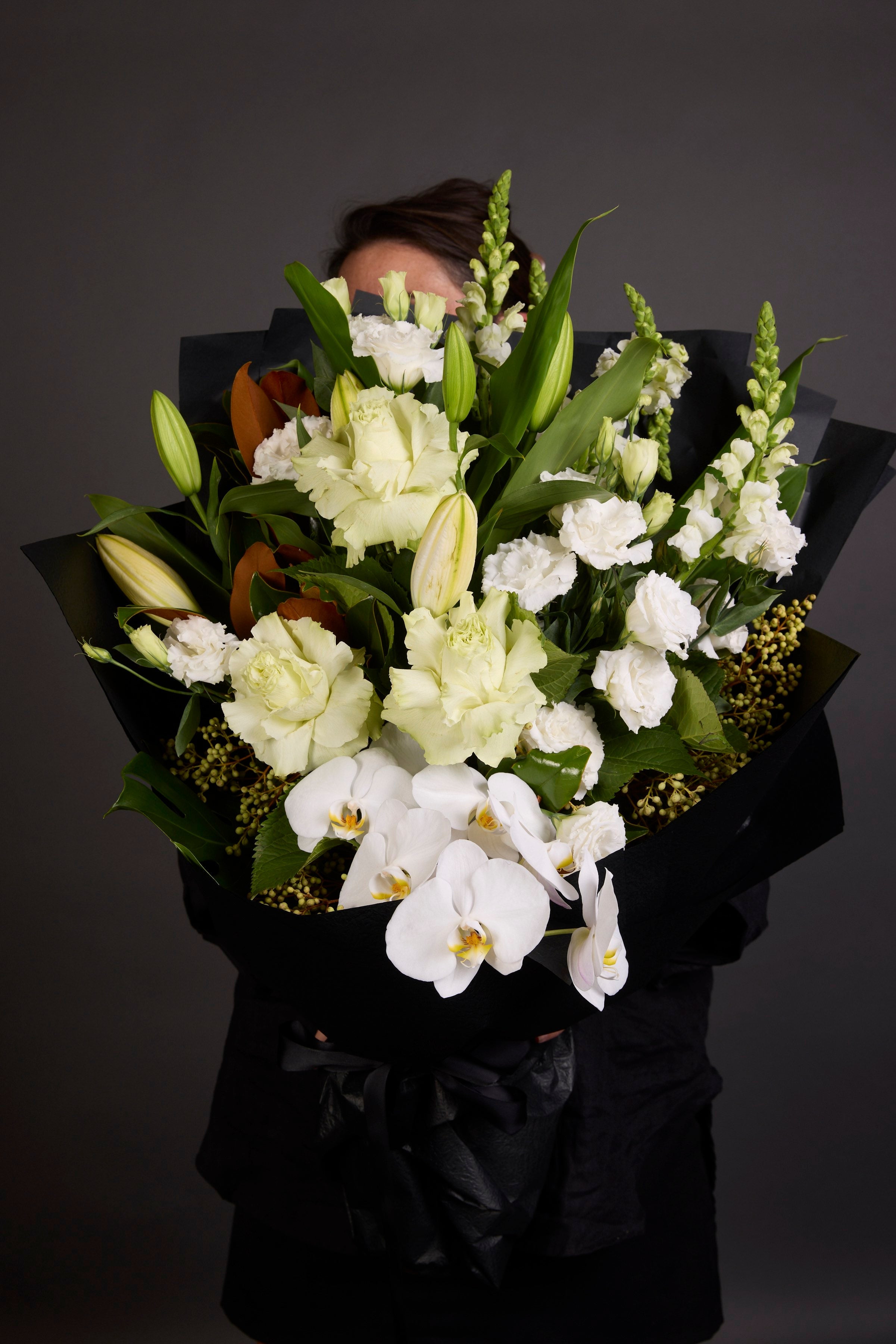Elegant sympathy flower arrangement by Victoria Whitelaw featuring seasonal blooms in soft, calming tones