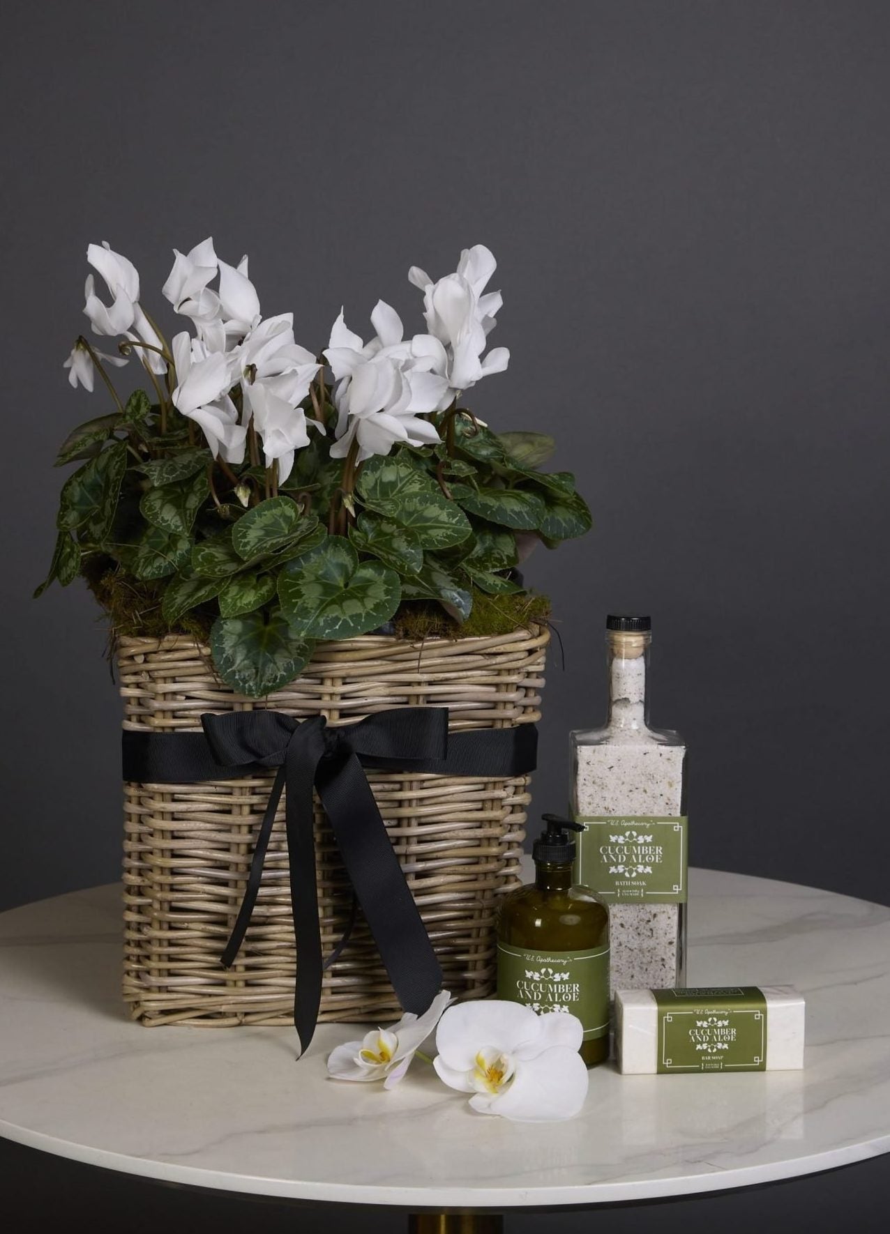 Cyclamen plant in woven basket with US Apothecary bath salts, hand lotion, and soap – Victoria Whitelaw gift set for delivery in Melbourne
