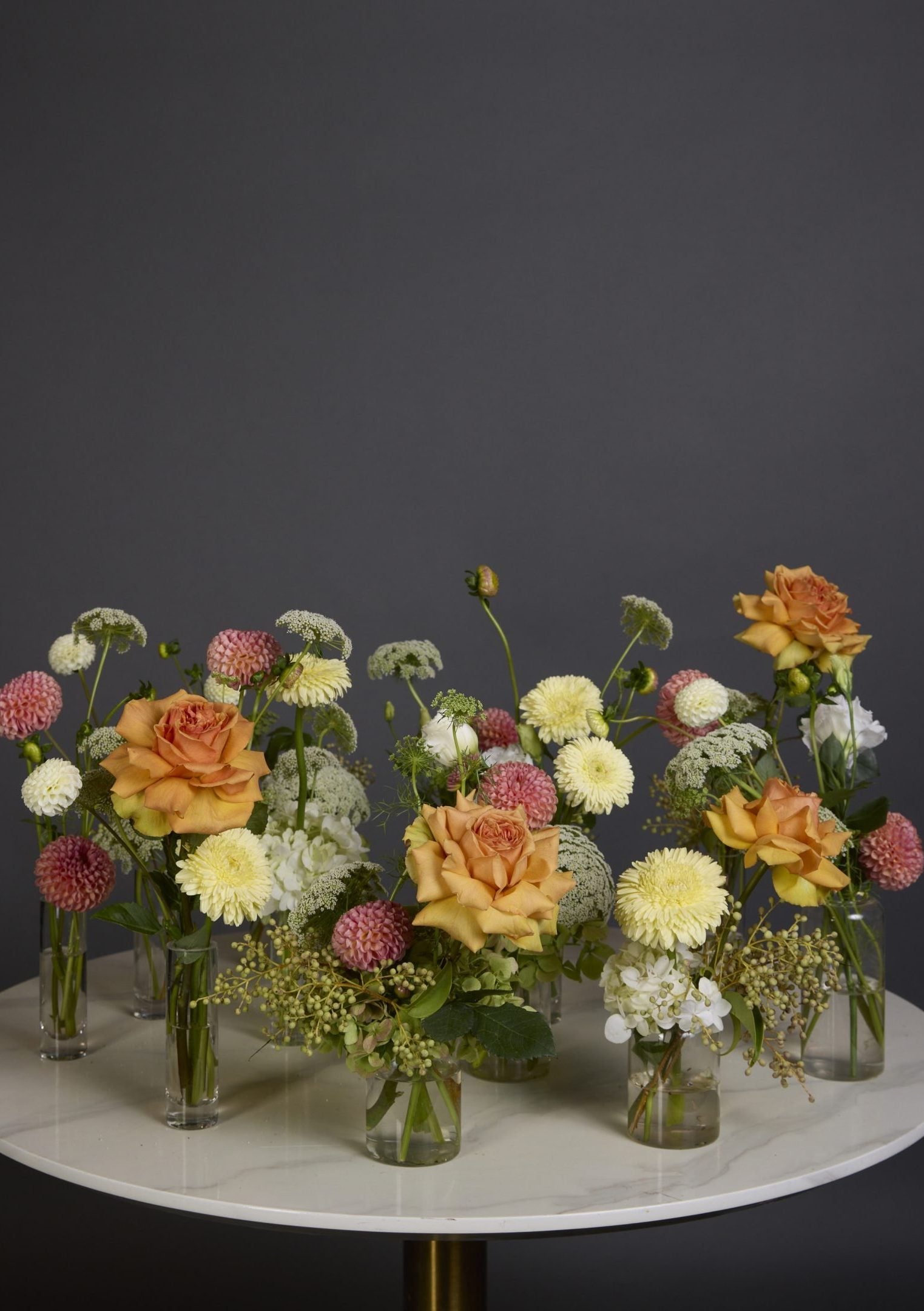 Glass Bud Vases Collection featuring assorted seasonal blooms in pastel or vibrant hues