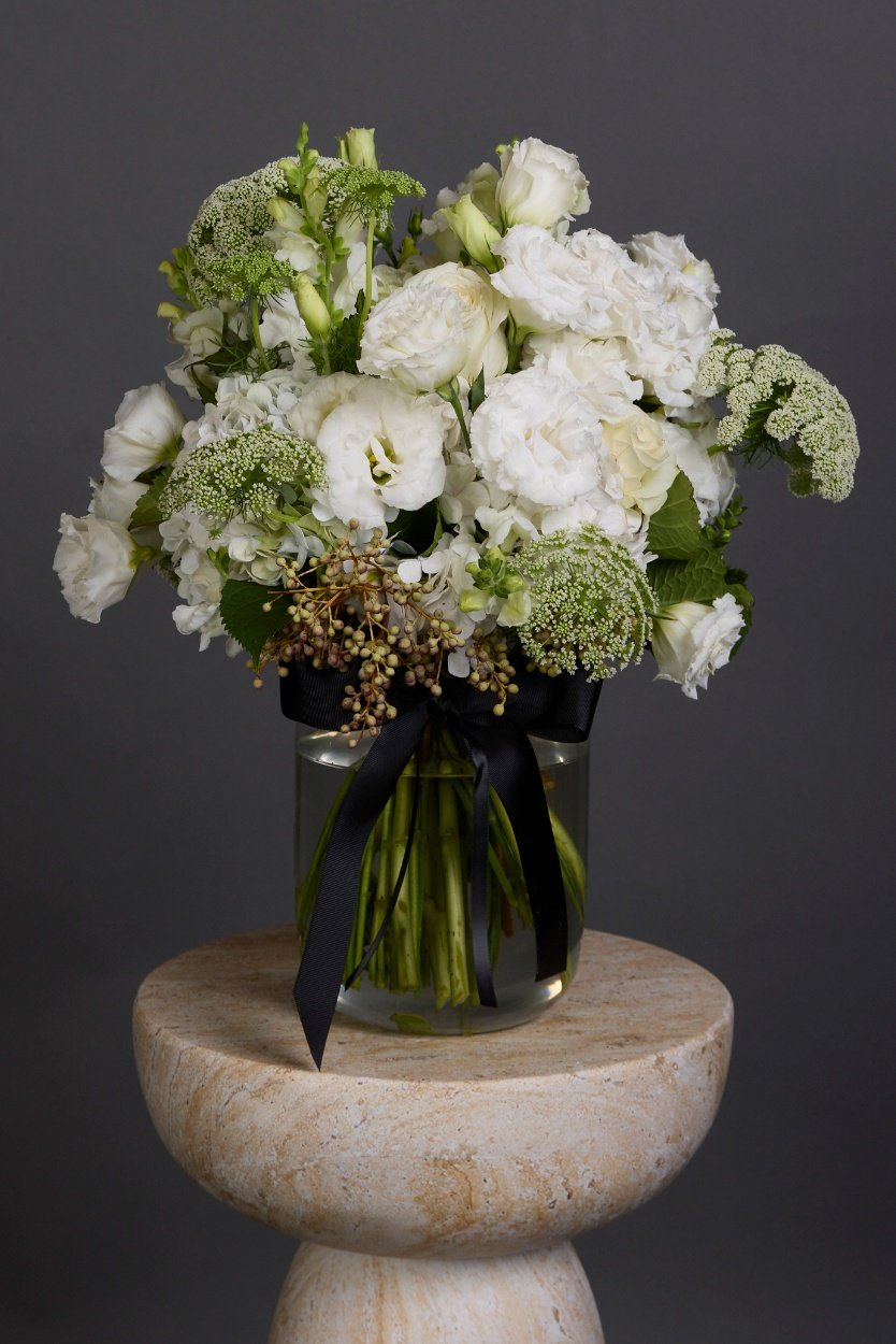 Darling posy of timeless white seasonal flowers and lush textured foliages