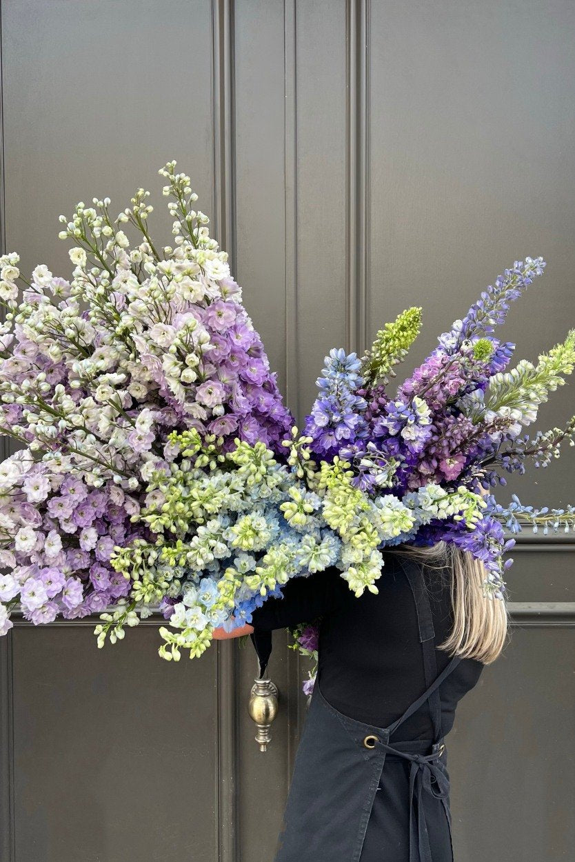 July Birth Flower Bouquet featuring tall blue delphinium blooms with foliage accents
