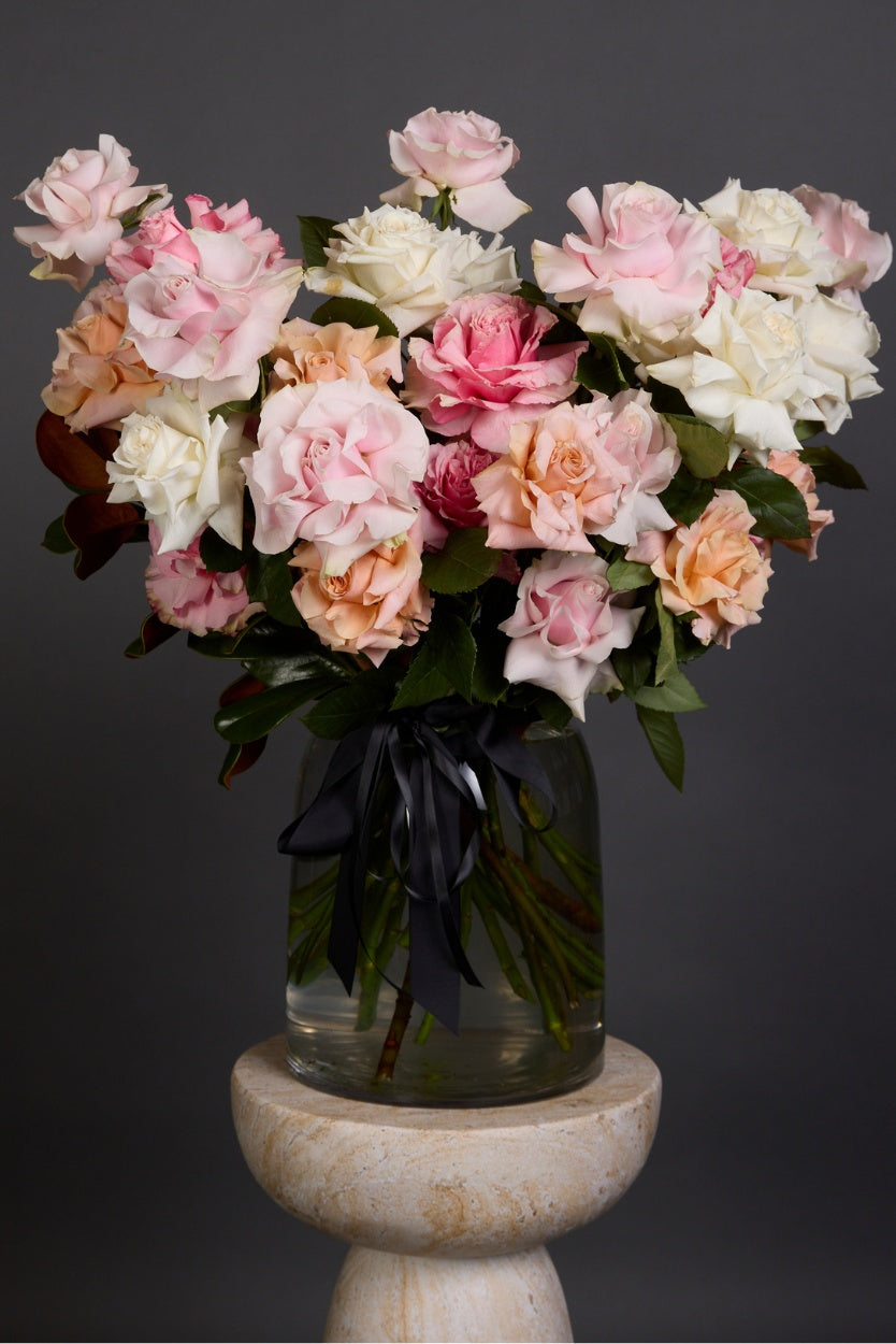 Dreamy bouquet of pastel reflexed roses with luscious seasonal foliage