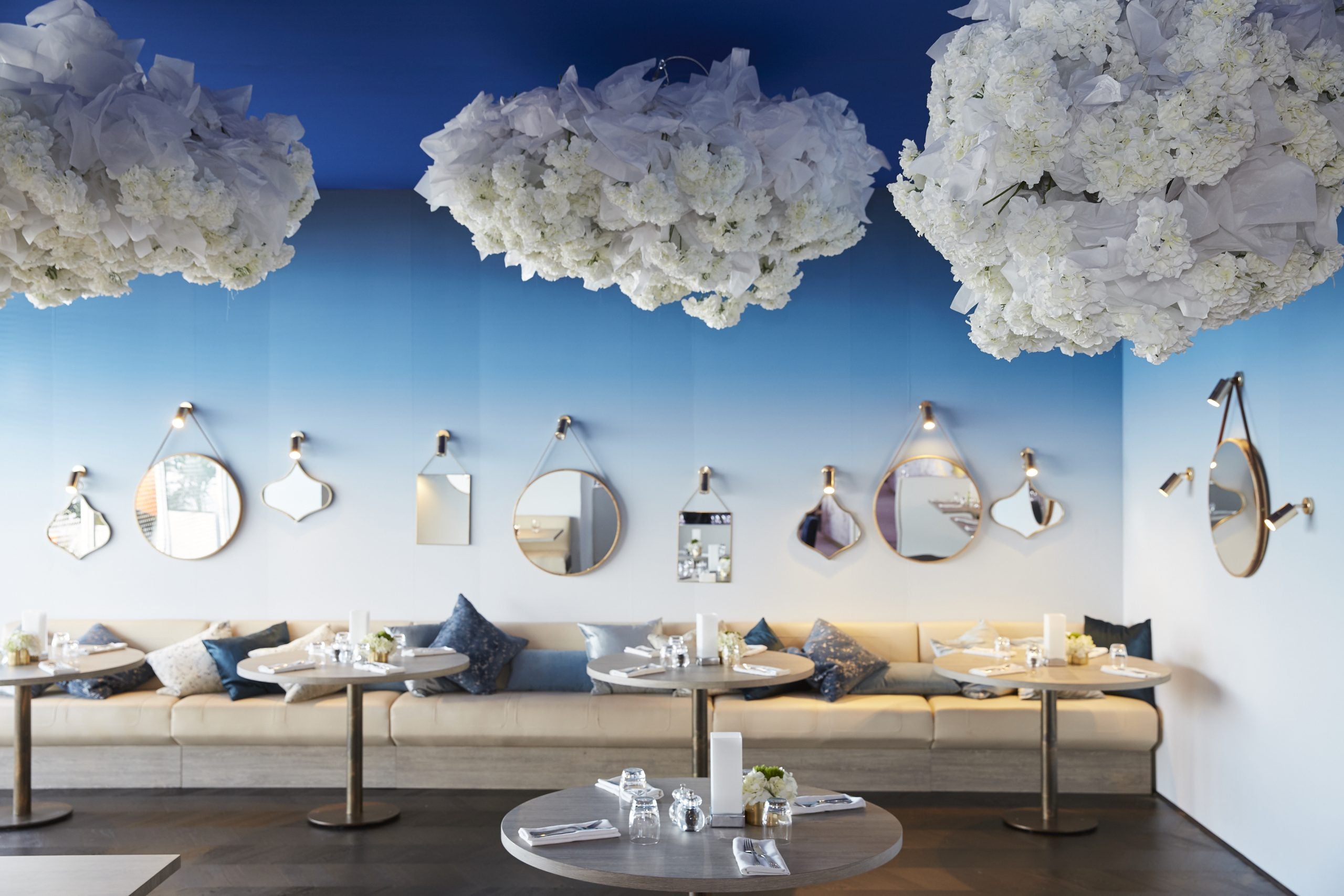 Modern spring racing carnival suite with floral chandeliers and decorative mirrors.