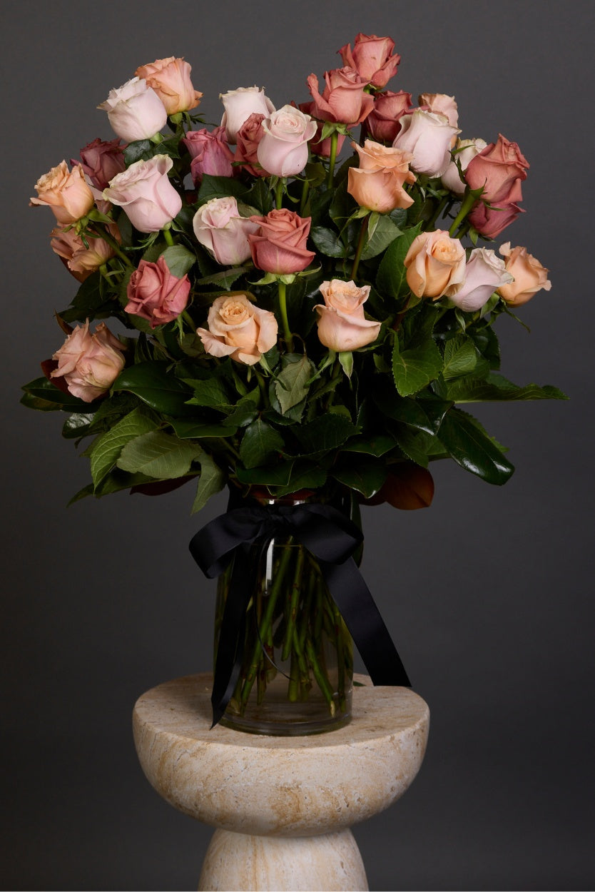 Pastelle bouquet with large-headed pastel roses and lush seasonal foliage