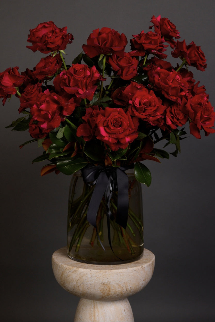 A timeless bouquet, Rosa features premium, long-stemmed red roses presented with luscious seasonal foliages