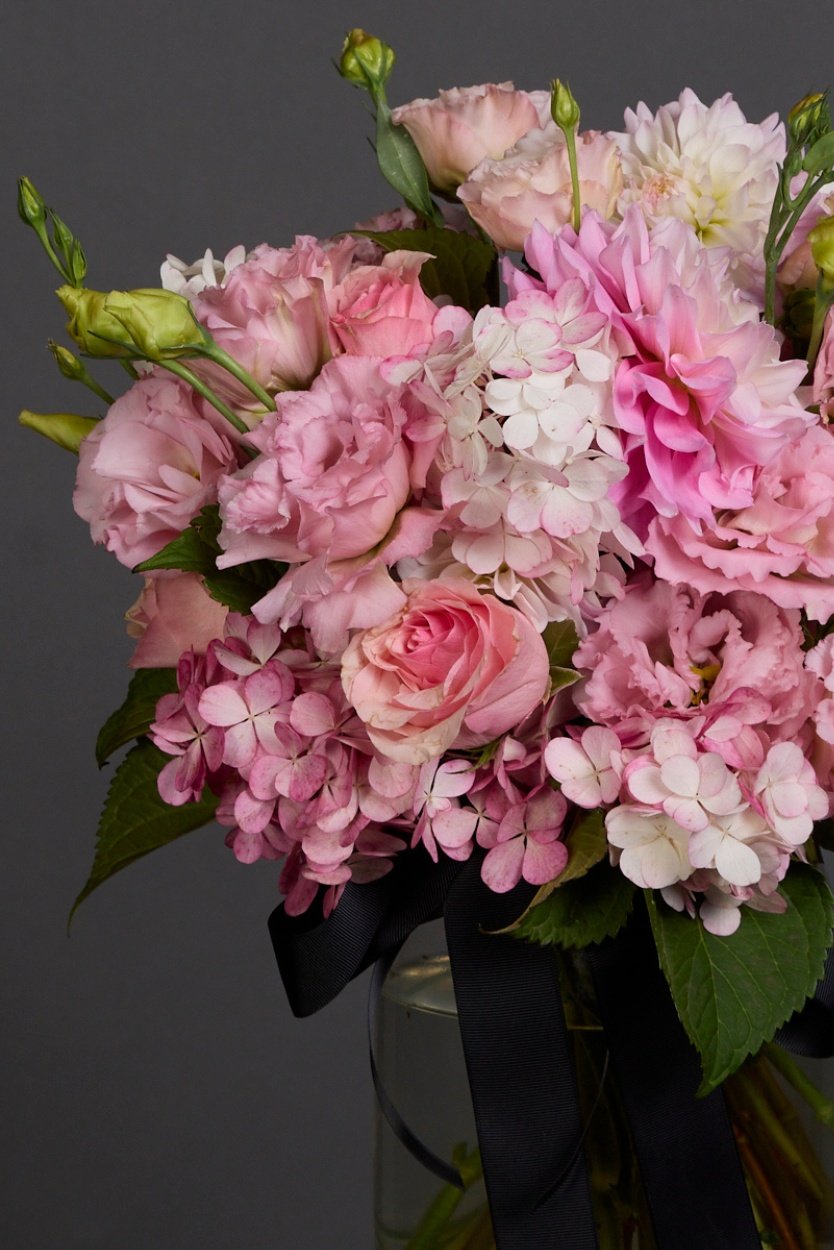 A pink bouquet of flowers hues crafted into a posy with luscious foliage, melbourne