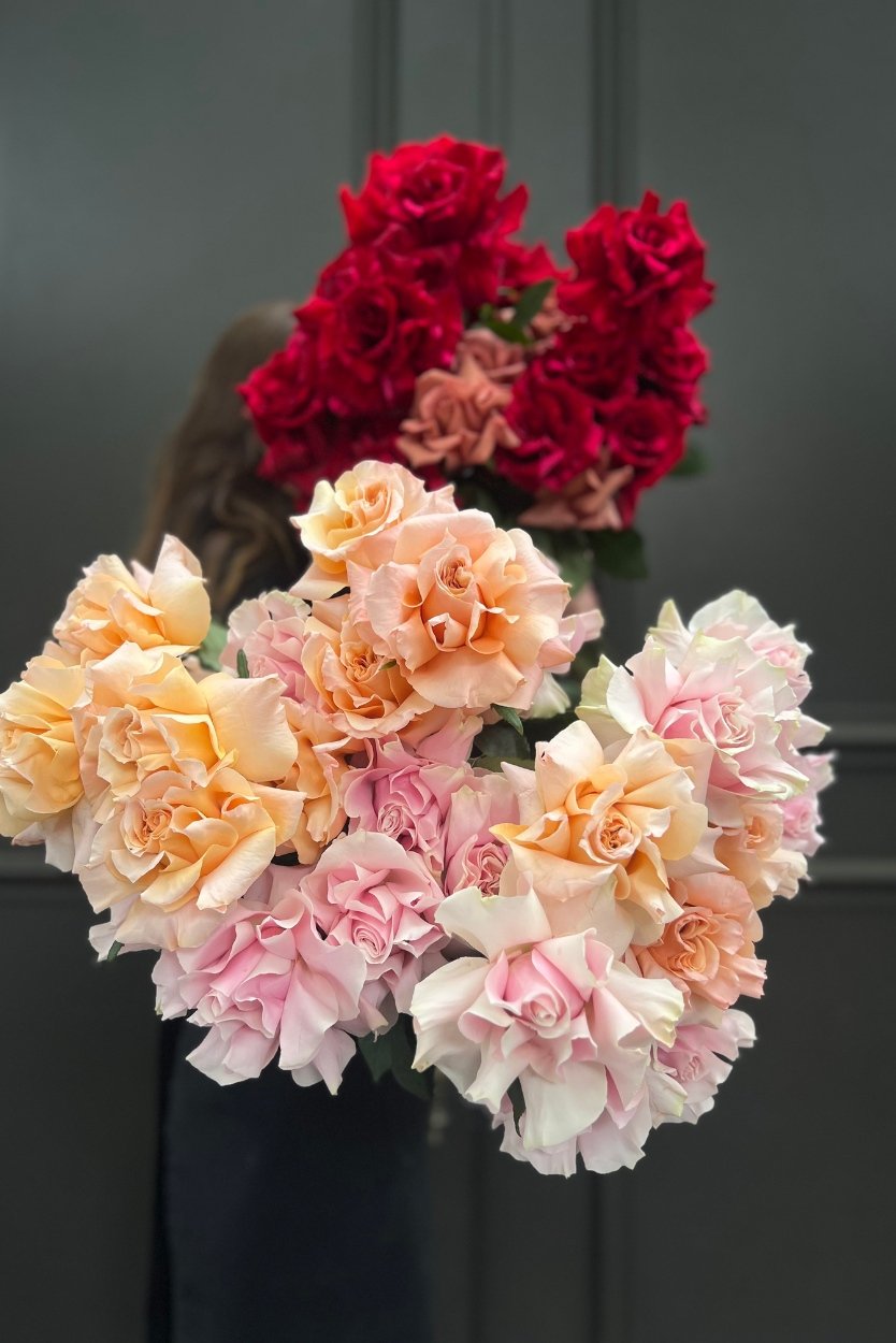 June Birth Flower Bouquet featuring massed premium roses with seasonal greens