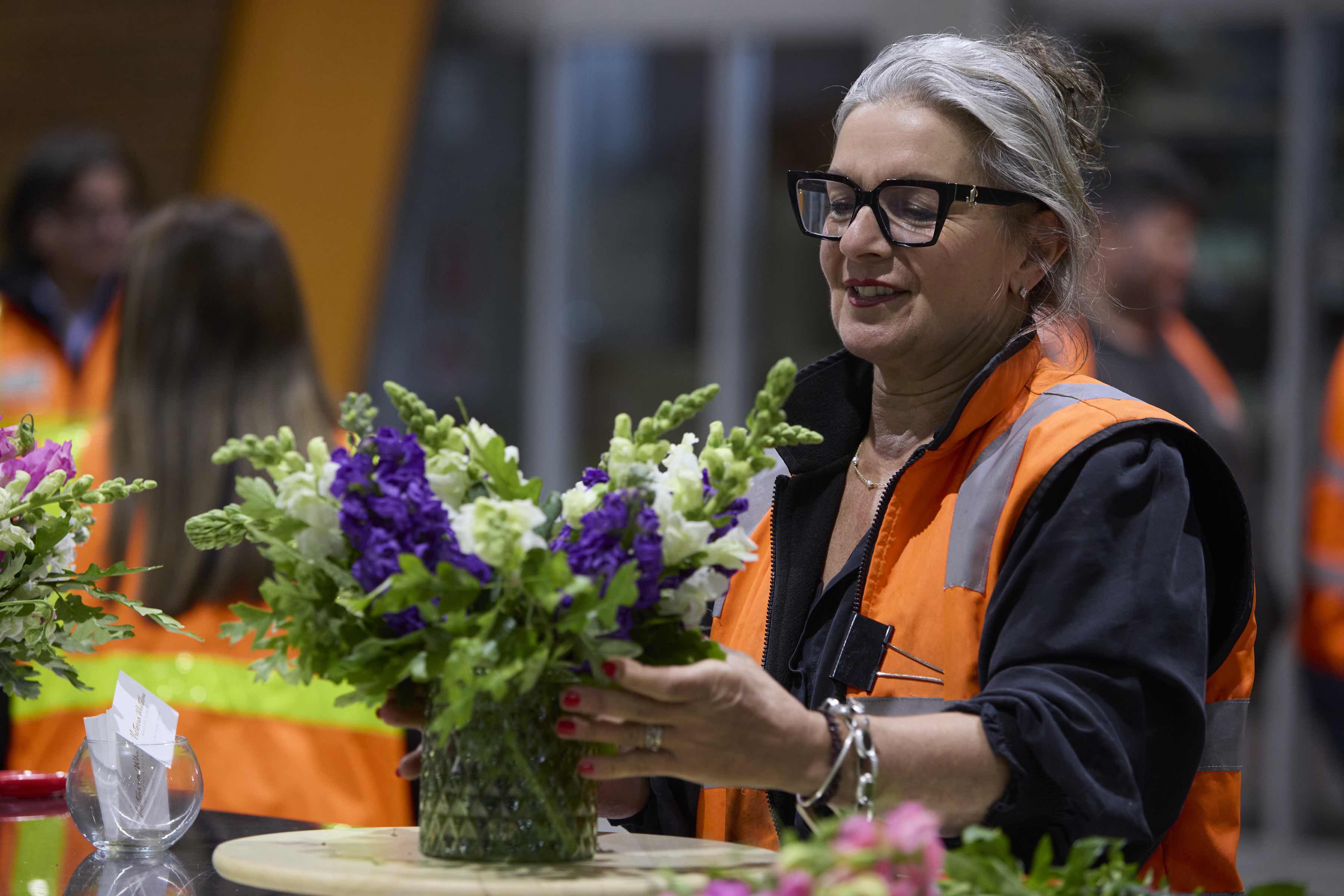 Victoria Whitelaw teaching a floral design class, demonstrating bouquet techniques with seasonal blooms.