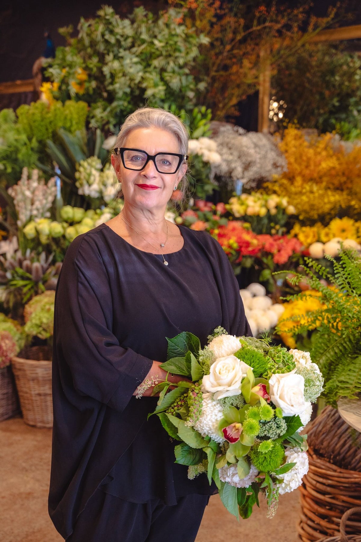 Victoria Whitelaw holds a white and green floral bouquet in the South Yarra store.