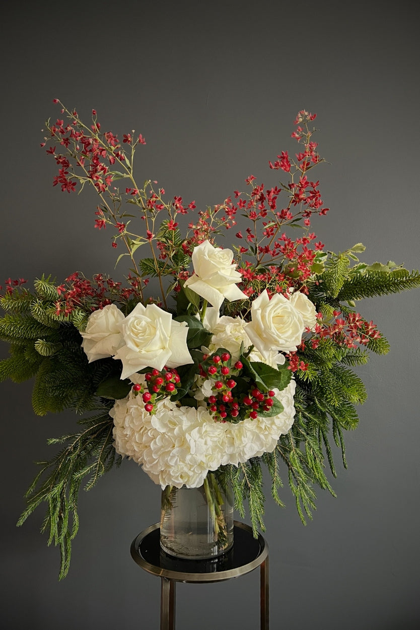 seasonal summer blooms, berries, and festive spruce and holly foliages