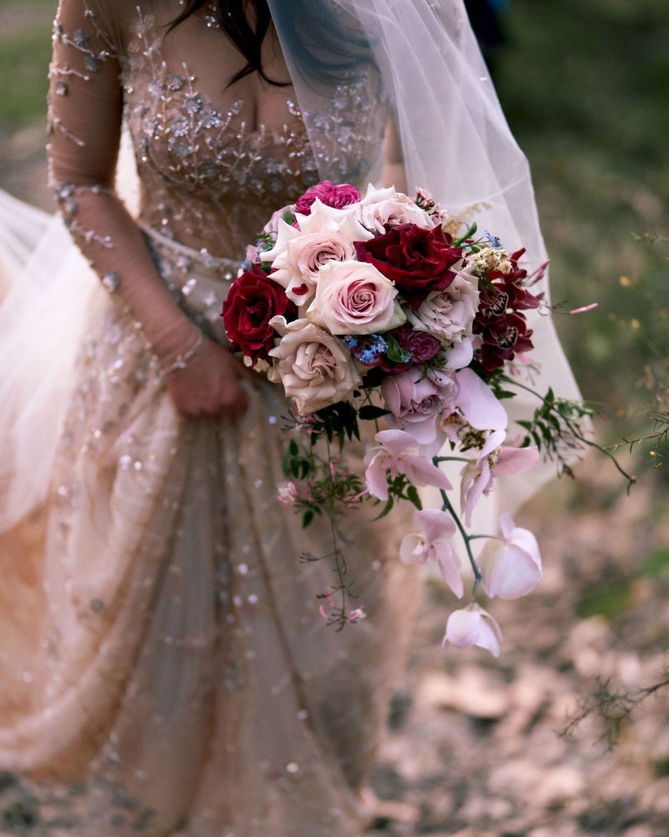 Bride holding a bouquet of flowers with a blurred natural background
