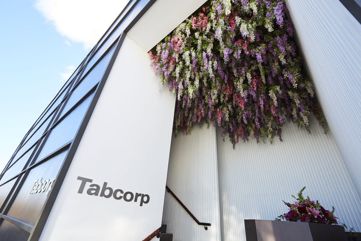 Tabcorp building installation with a floral display on a clear day