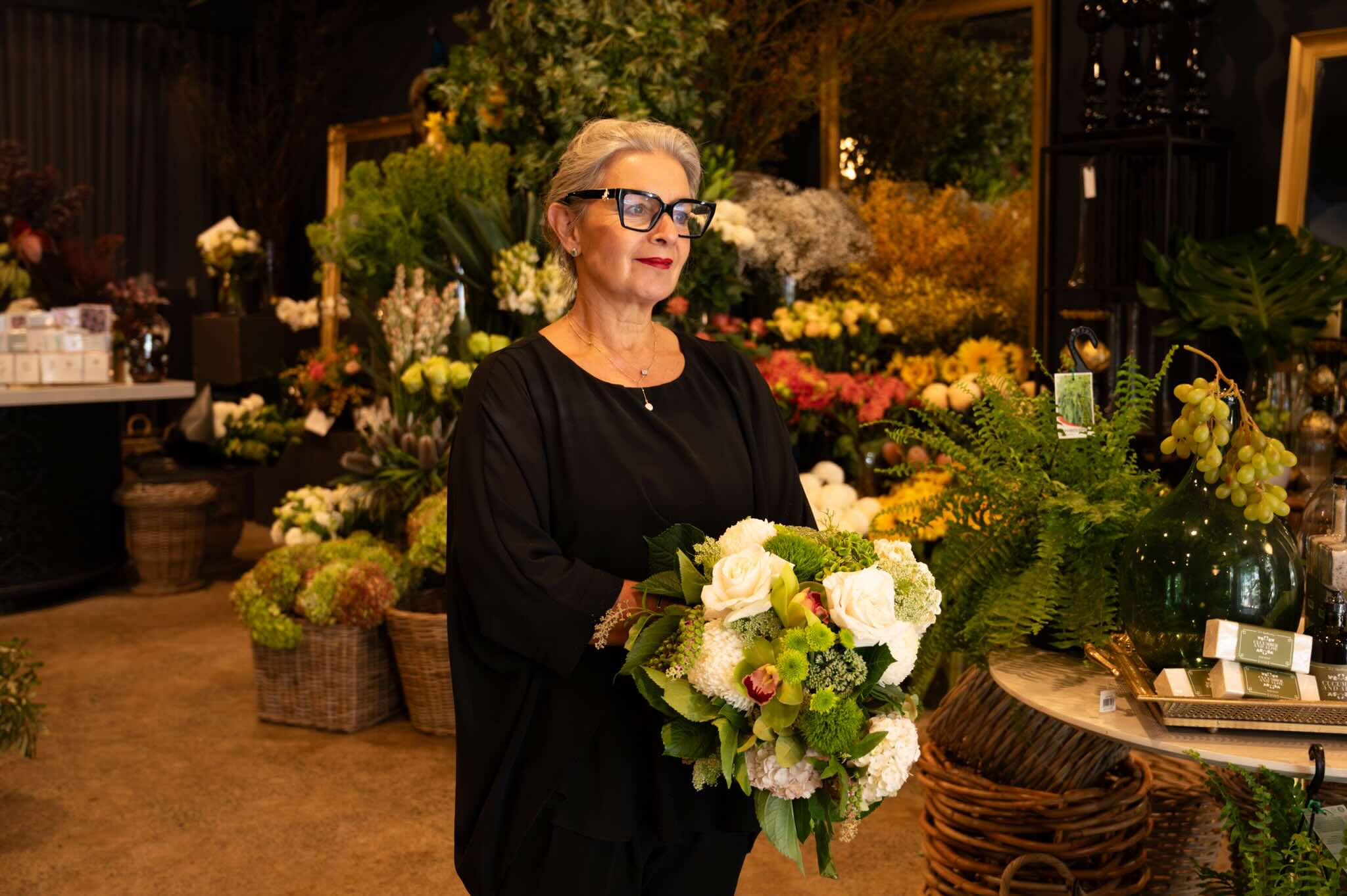 Victoria Whitelaw holding bouquet of flowers in south yarra store